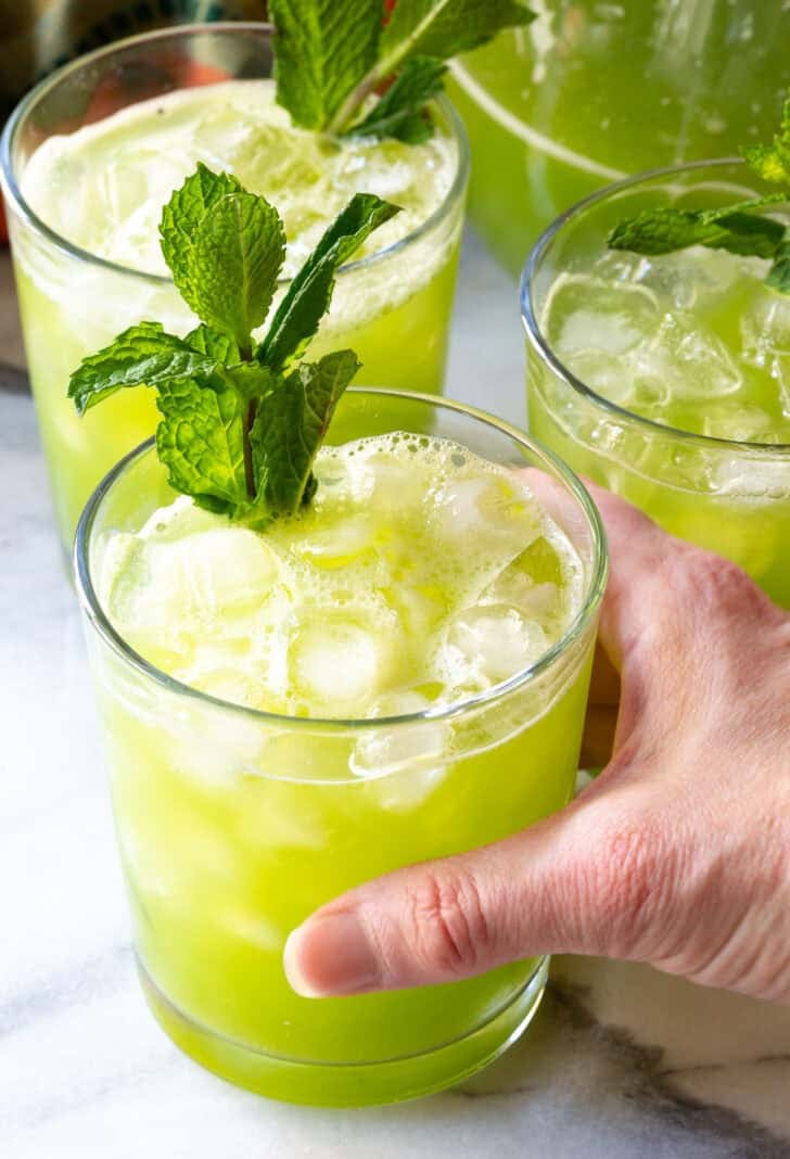 hand reaching for Cucumber Ginger Mint Agua Fresca