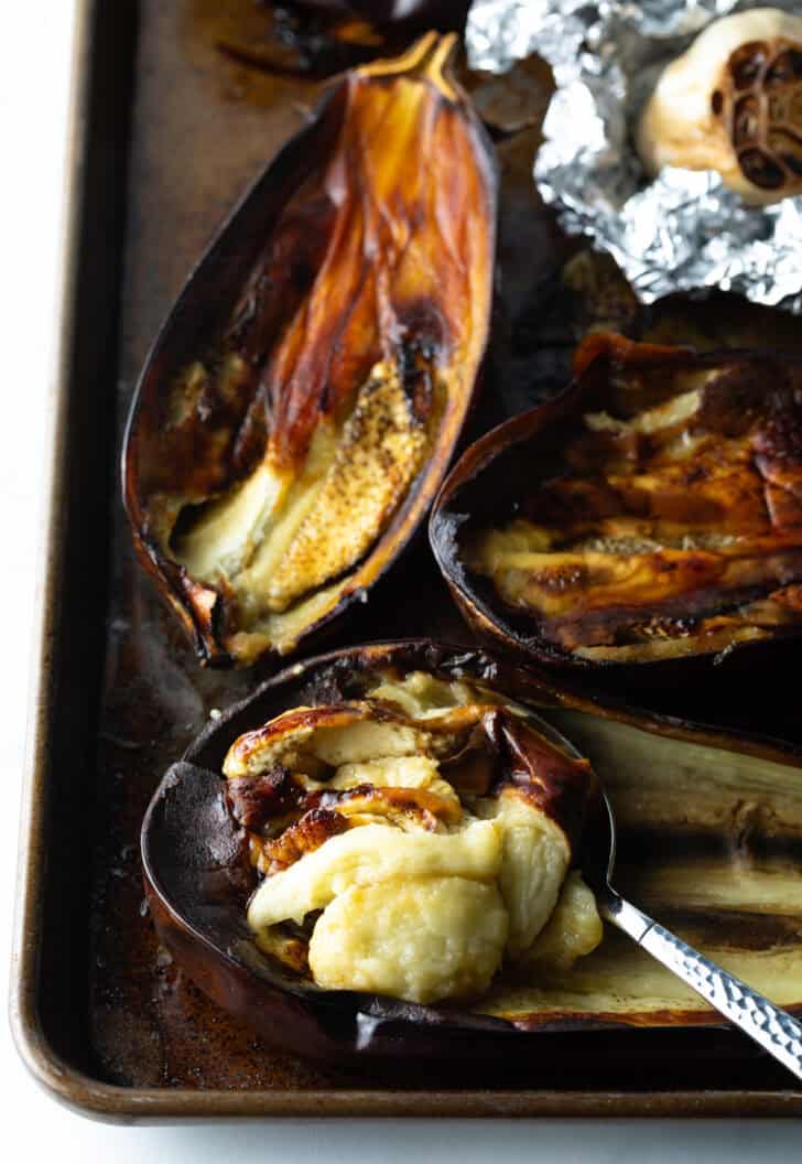 Roasted eggplant halves with meat scooped out.
