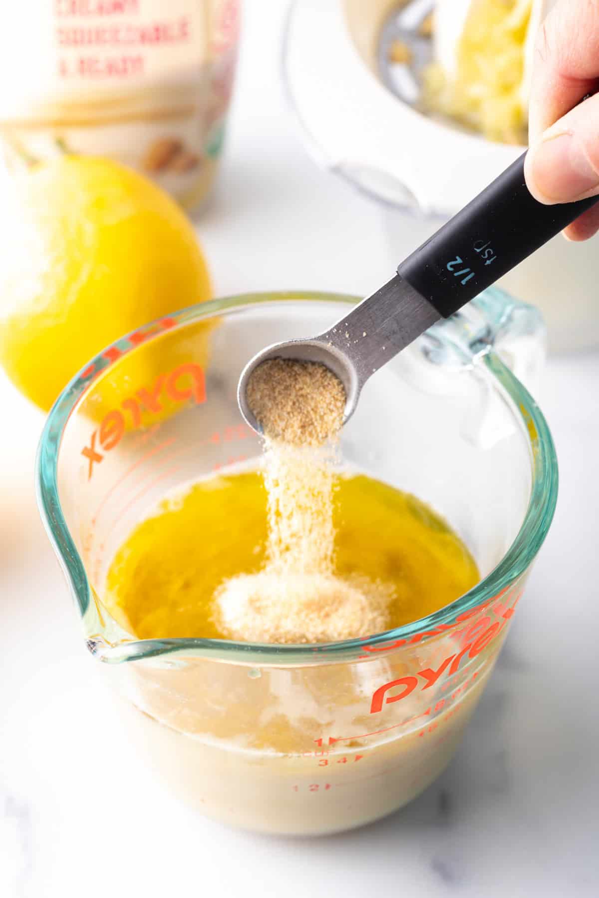 Ingredients being measured and added to container. 