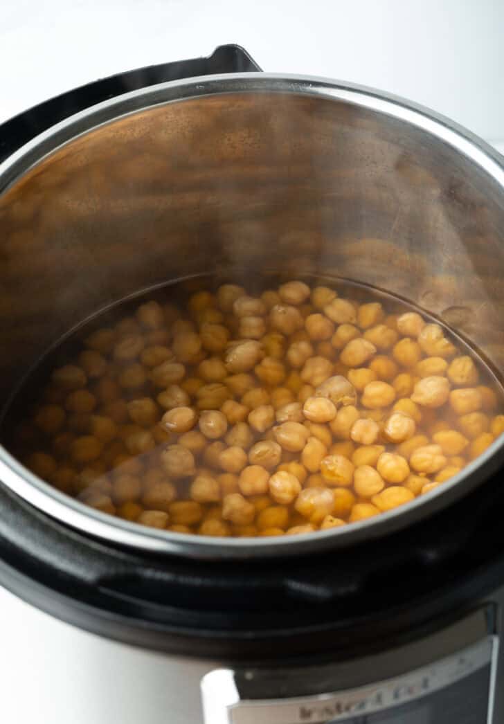 Instant pot with chickpeas and water.