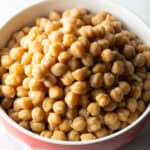 Red bowl of cooked chickpeas.