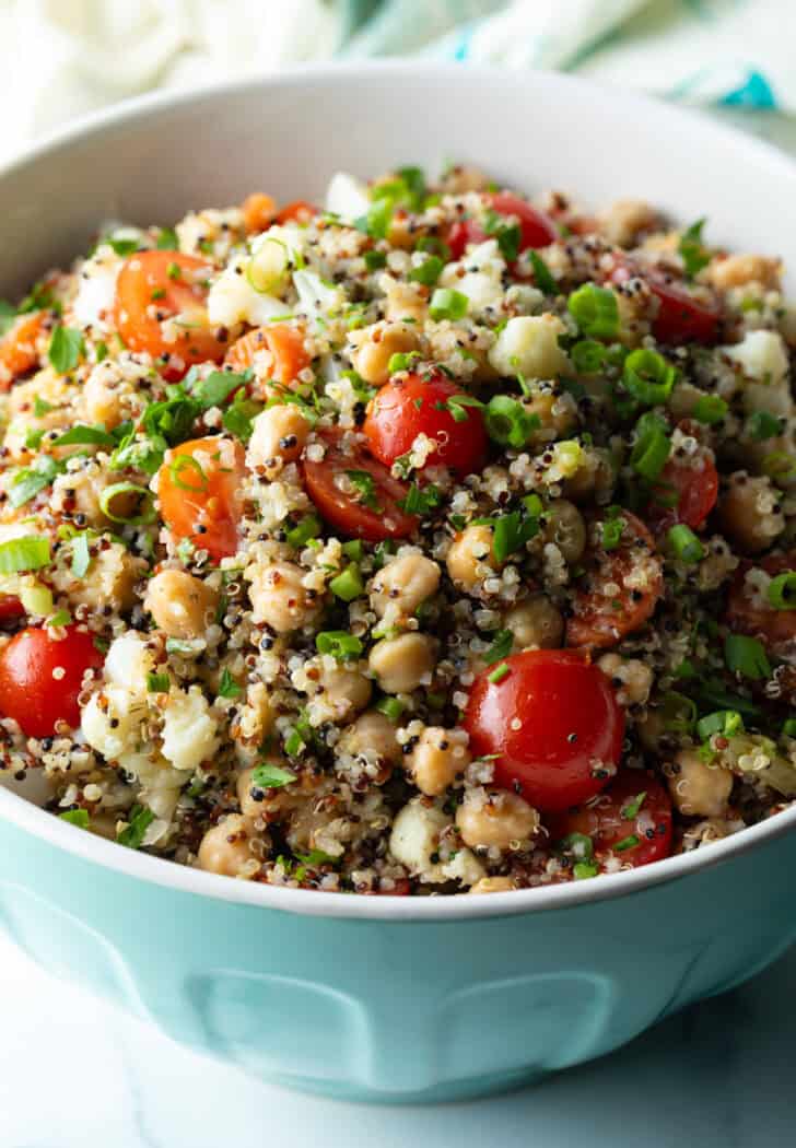 Bowl of chickpea salad with tomatoes.