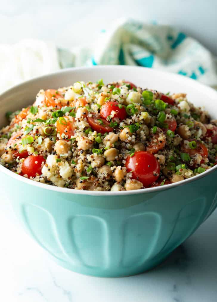 Bowl of chickpea salad with tomatoes.