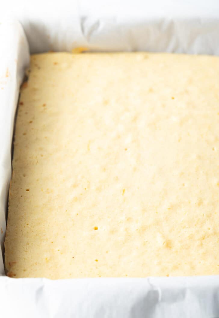 Baked base of the lemon blondies in a large rectangle baking pan.