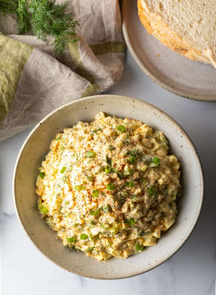 Top down view white bowl of deviled egg salad.