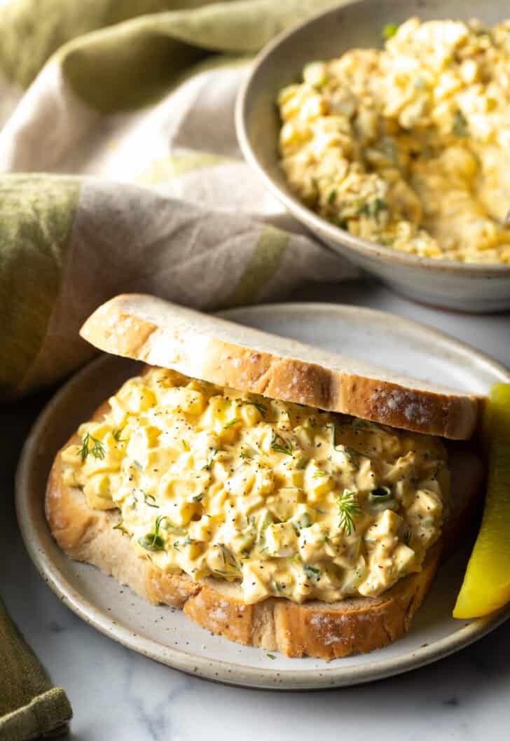 Deviled egg salad sandwich on a plate.