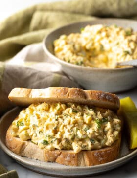 Deviled egg salad sandwich on a plate.