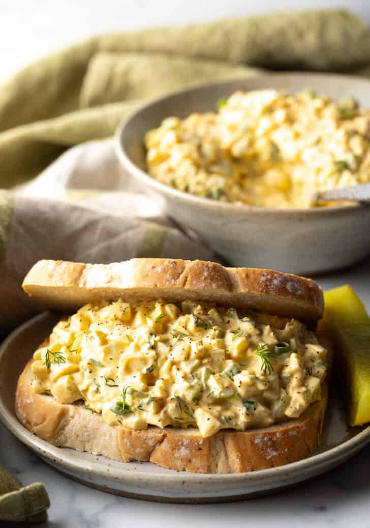 Deviled egg salad sandwich on a plate.