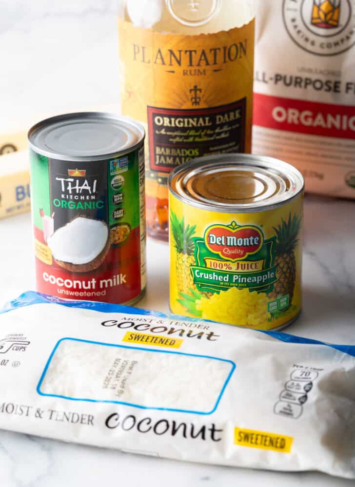 Can of coconut milk and crushed pineapple on a counter.