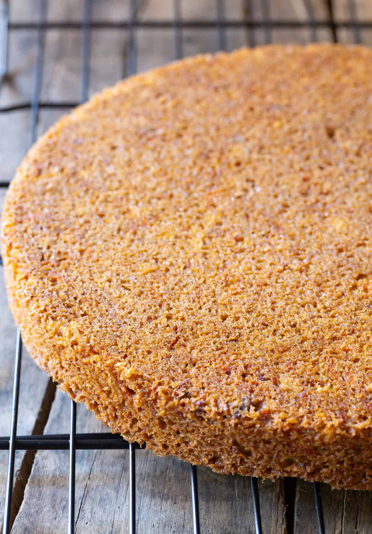 Baked carrot cake layers on cooling rack.