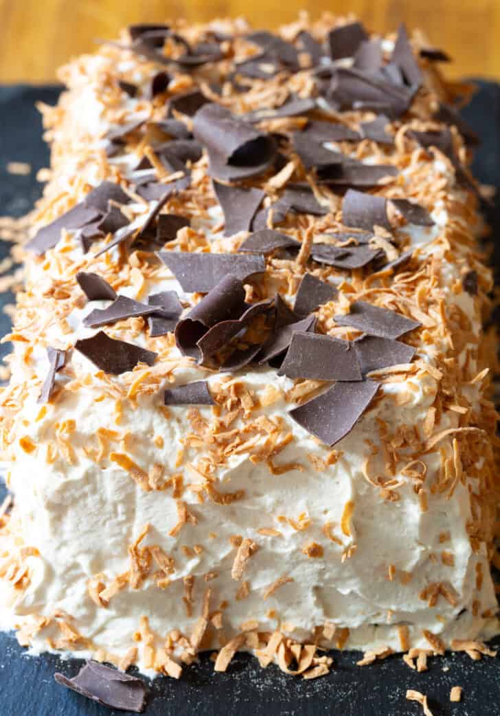 Ice box cake topped with toasted coconut and chocolate shavings.