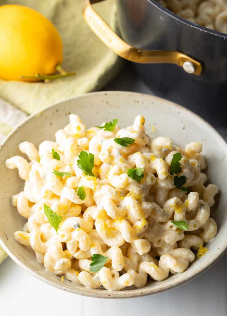 Large bowl of Boursin cheese pasta garnished with chopped parsley.