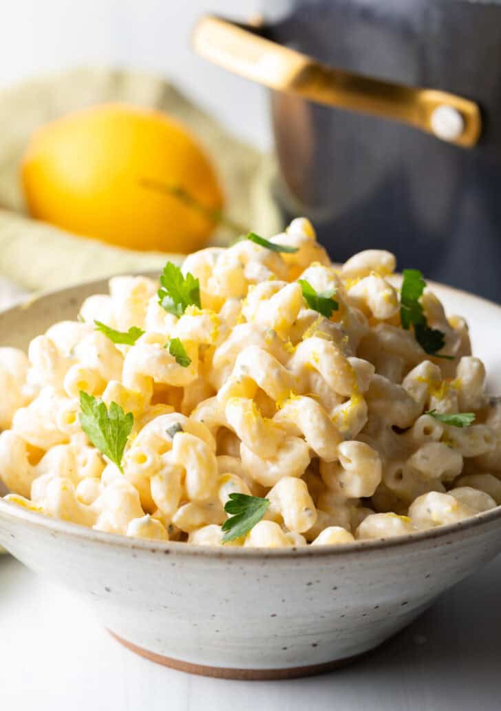 Large bowl of Boursin cheese pasta garnished with chopped parsley.