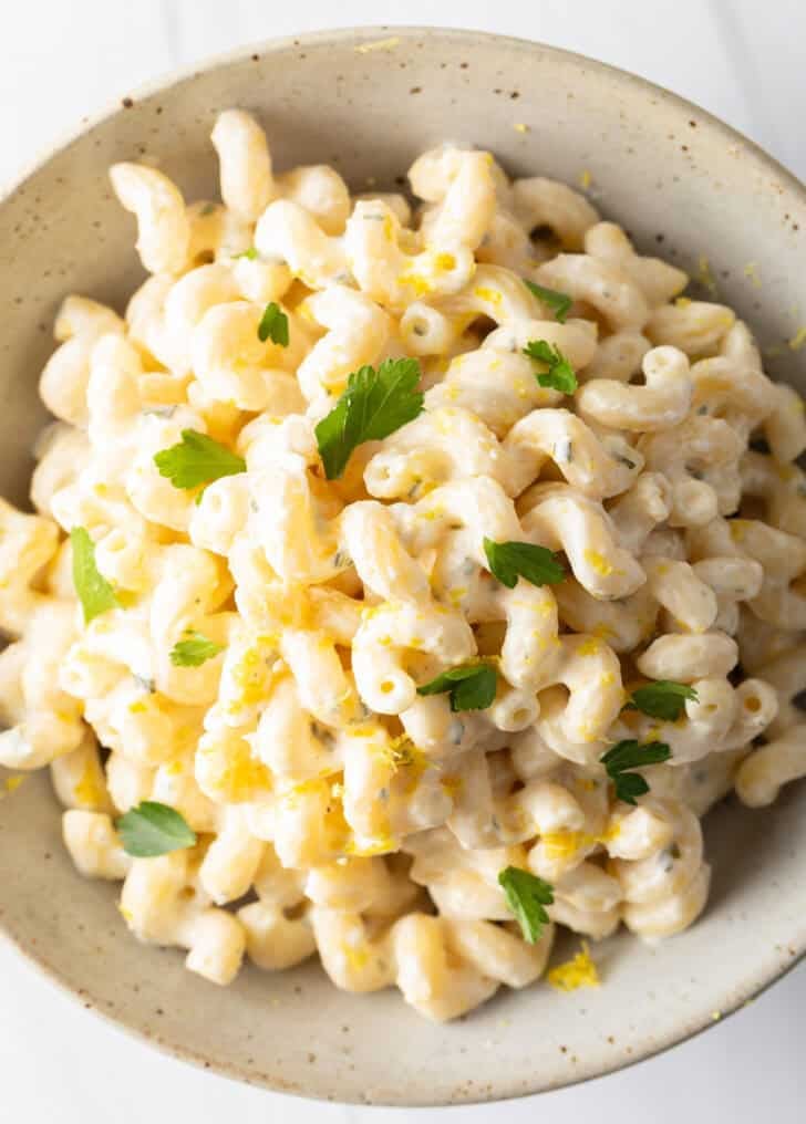 Large bowl of Boursin cheese pasta garnished with chopped parsley.