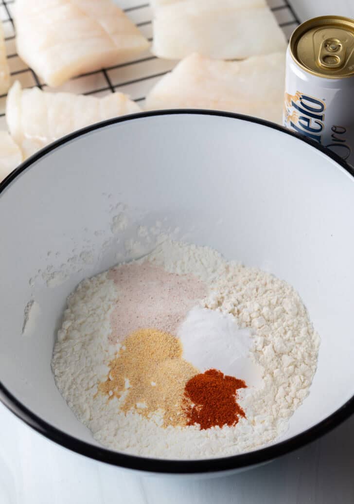 White bowl with dry ingredients for fish breading.