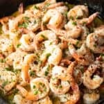 Shrimp in a skillet with herbs and garlic.