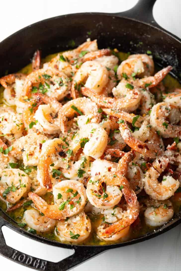 Shrimp in a skillet with herbs and garlic.