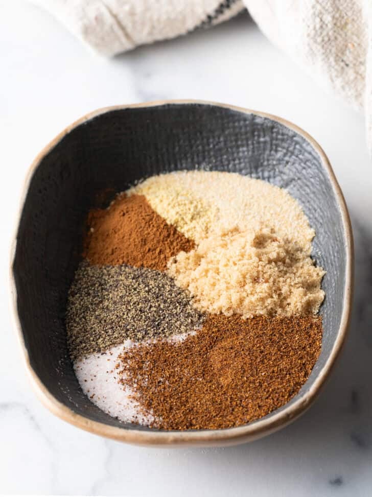 Oval bowl with different spices in piles.
