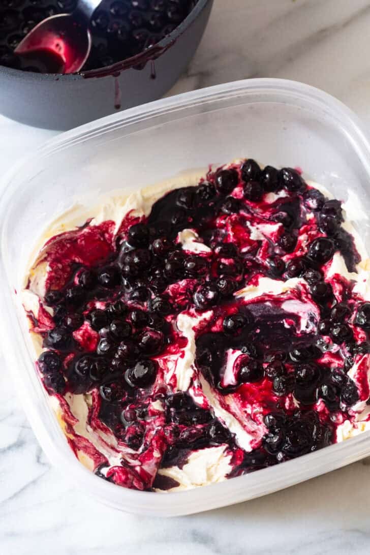 Swirling cooked blueberries into the blueberry pie ice cream.