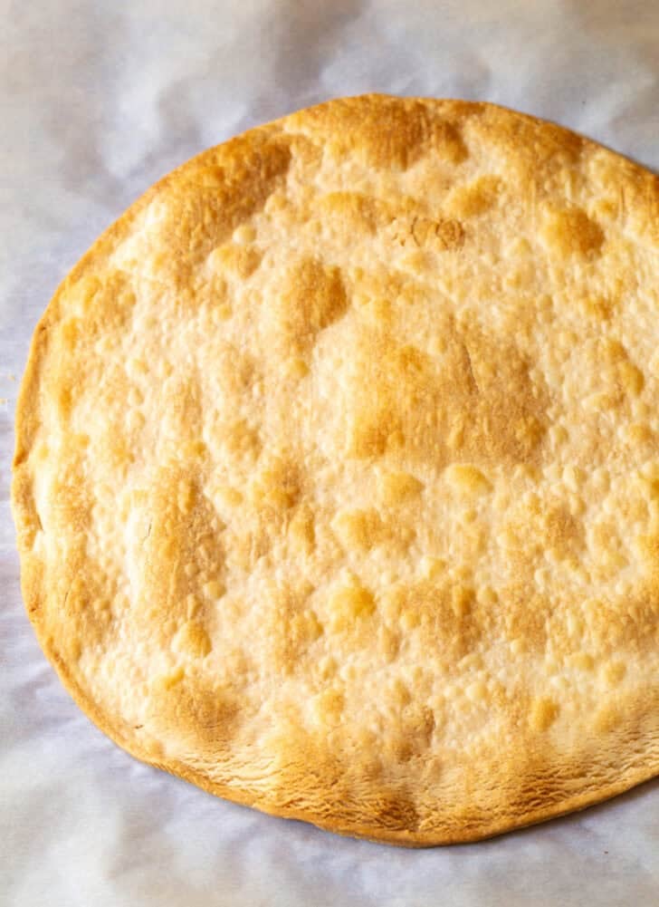 Large circular piece of baked pie crust.