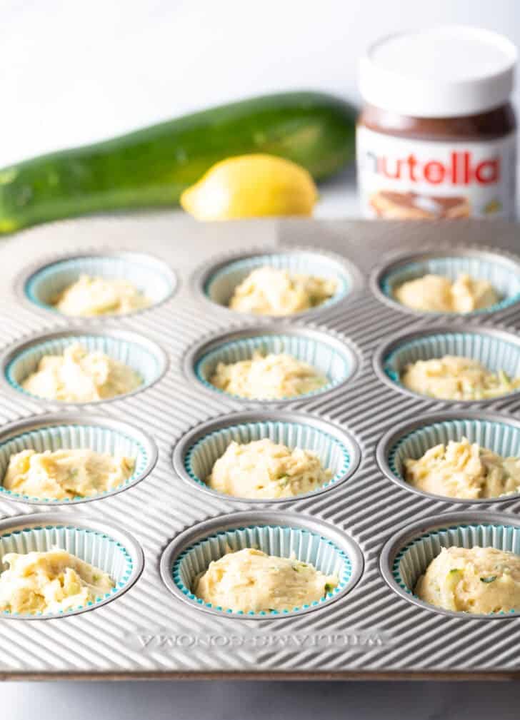 Muffin tin with batter in each well.