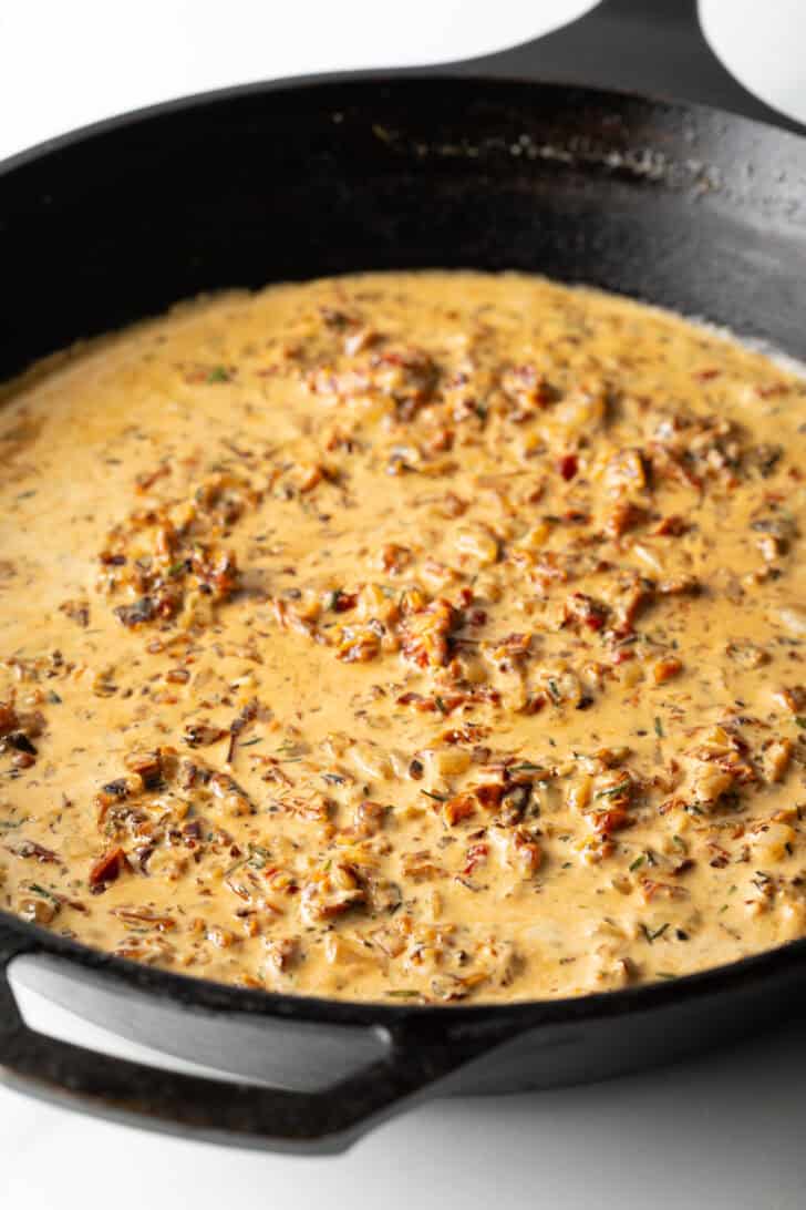 Cast iron skillet with creamy red pepper gravy.