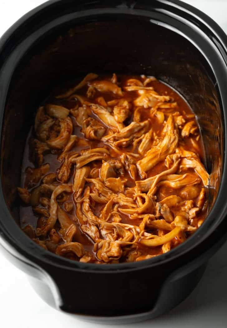 Shredded bbq chicken in a slow cooker.