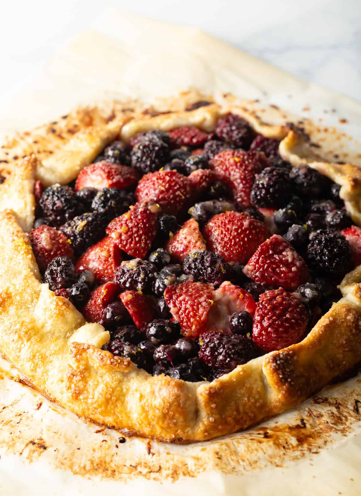 Baked crostata with blueberries, blackberries, and strawberries.