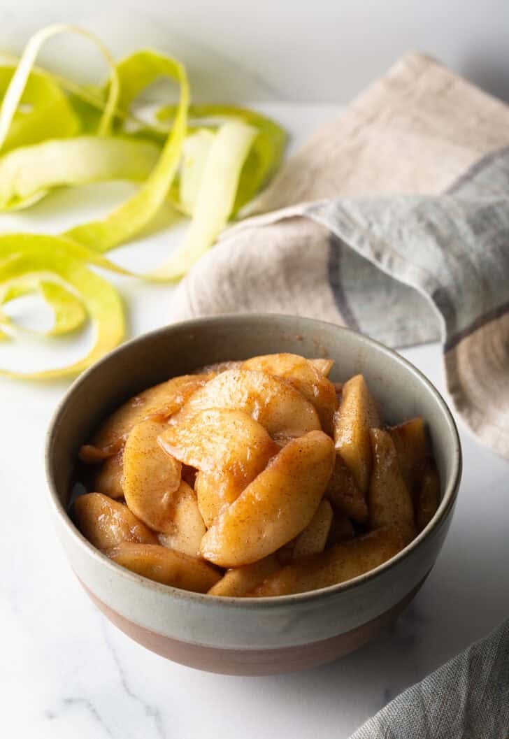 Serving of spiced apples in a gray bowl.