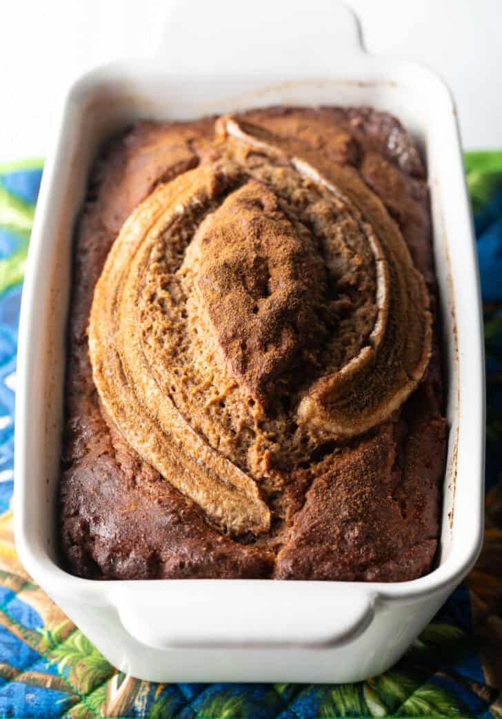 White loaf pan with healthy banana bread.