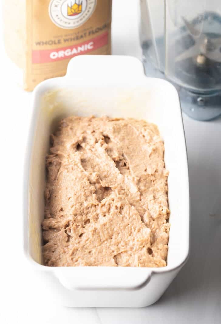 Batter in a white loaf pan.