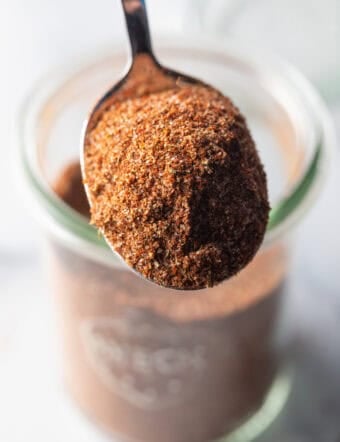 Spoonful of chicken taco seasoning held to camera.