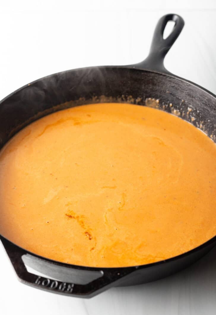 Rich tomato cream sauce in a cast iron skillet.