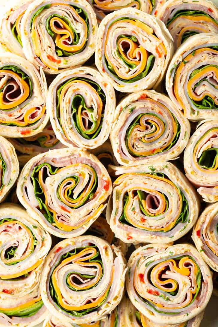 Close top down view of layers of a dozen pinwheels stacked on top of each other.