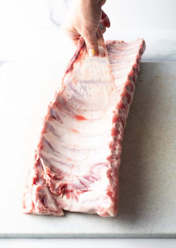 Raw rack of ribs on a white background.