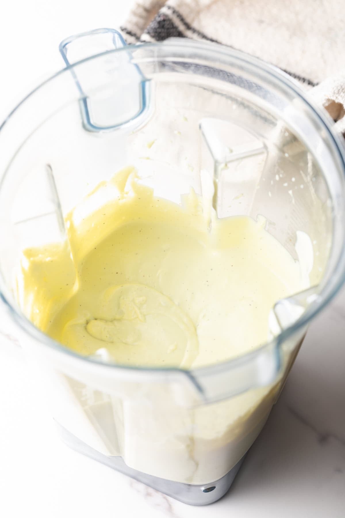 An avocado lime ranch dressing recipe is being made in a blender.