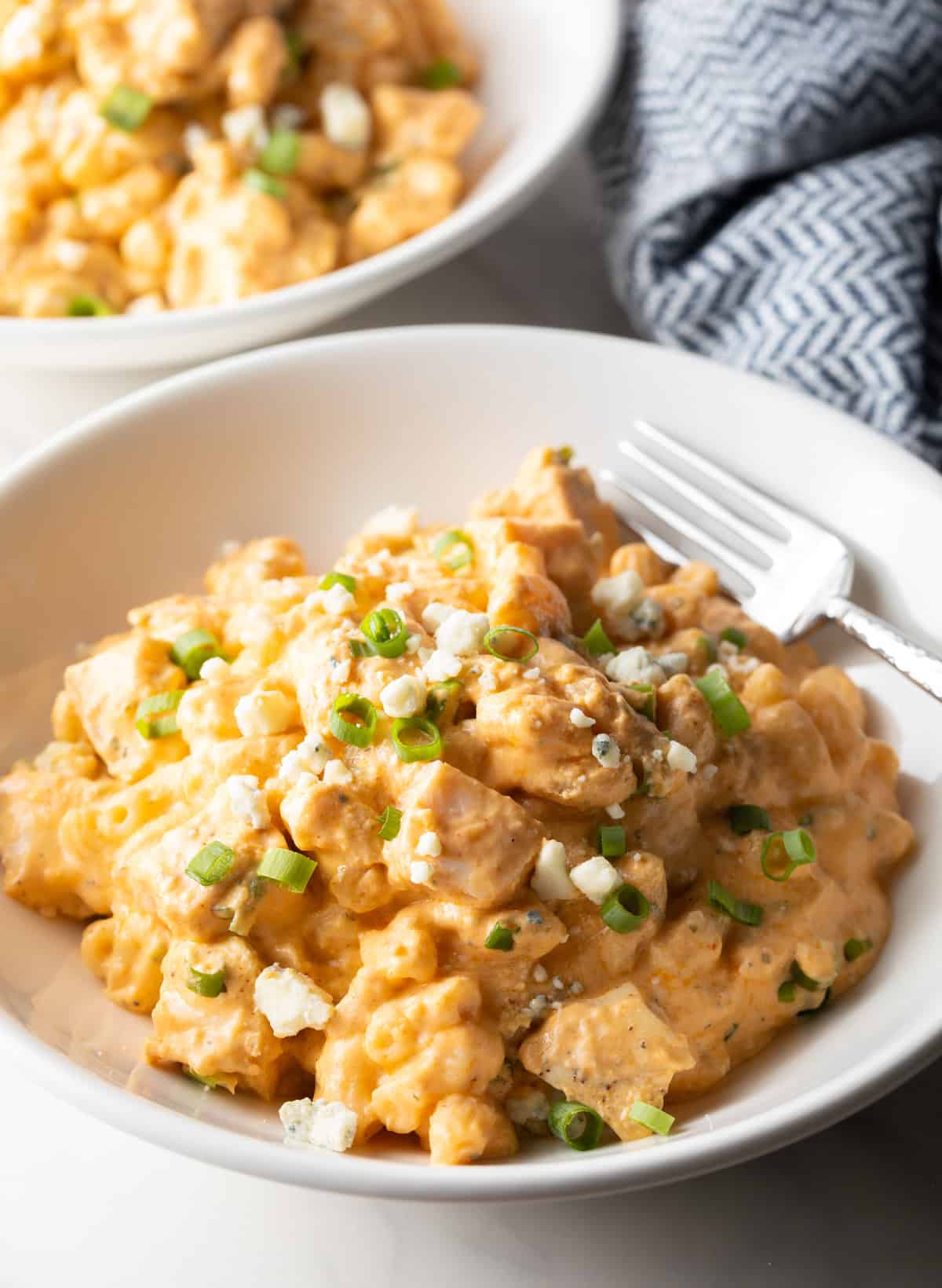 White bowl of creamy cheesy buffalo chicken mac n cheese.