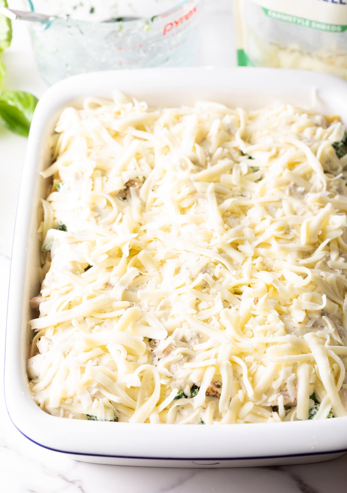 Shredded mozzarella cheese added on top of the lasagna.