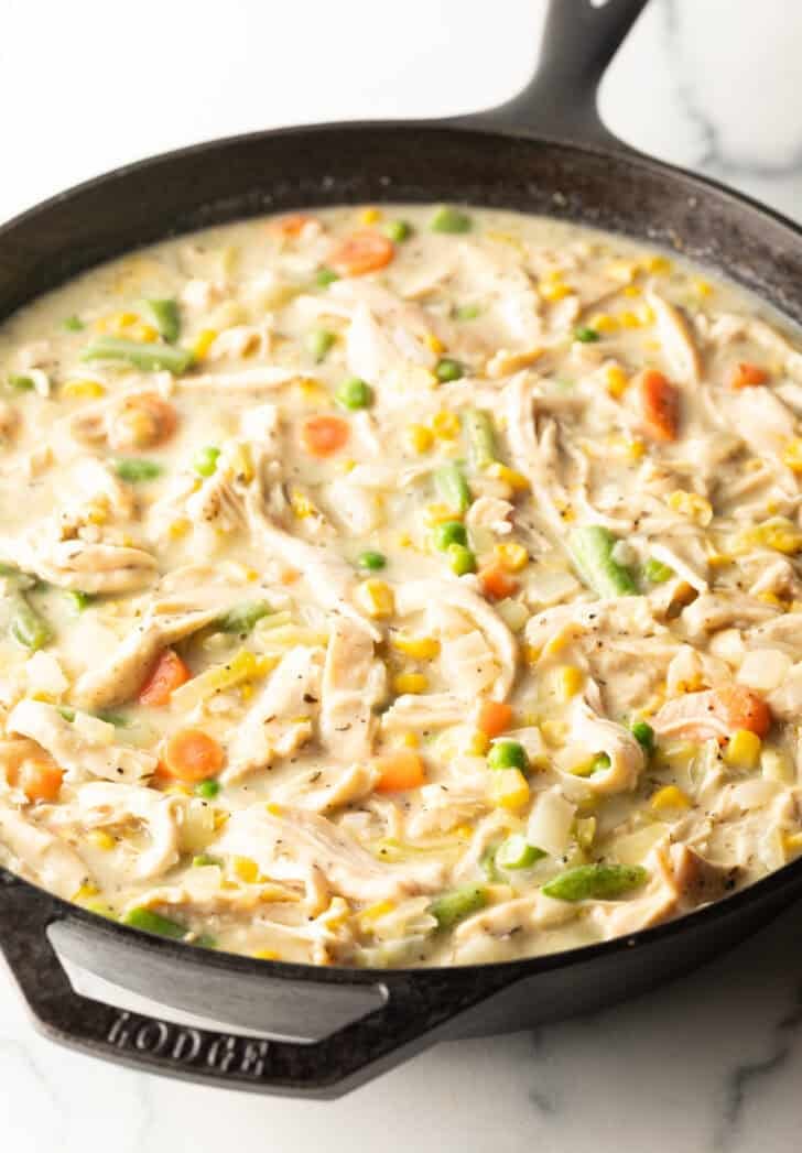 Cast iron skillet with creamy chicken and vegetables.