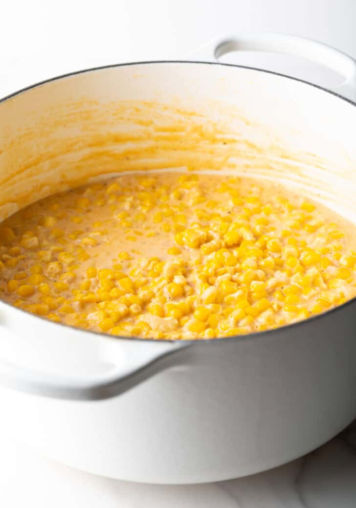 Creamed corn in a large white pot.