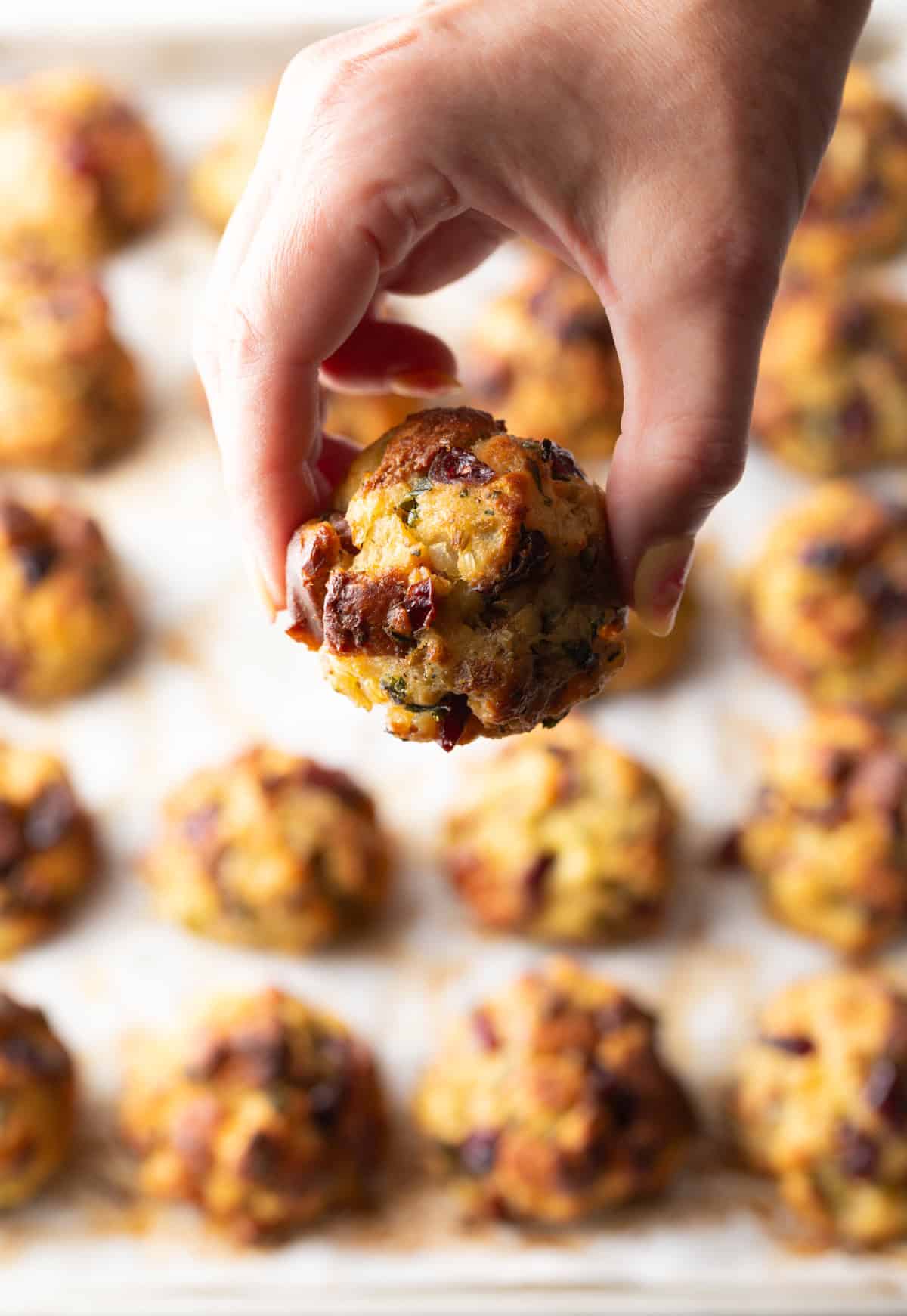 Hand holding a stuffing ball to camera.
