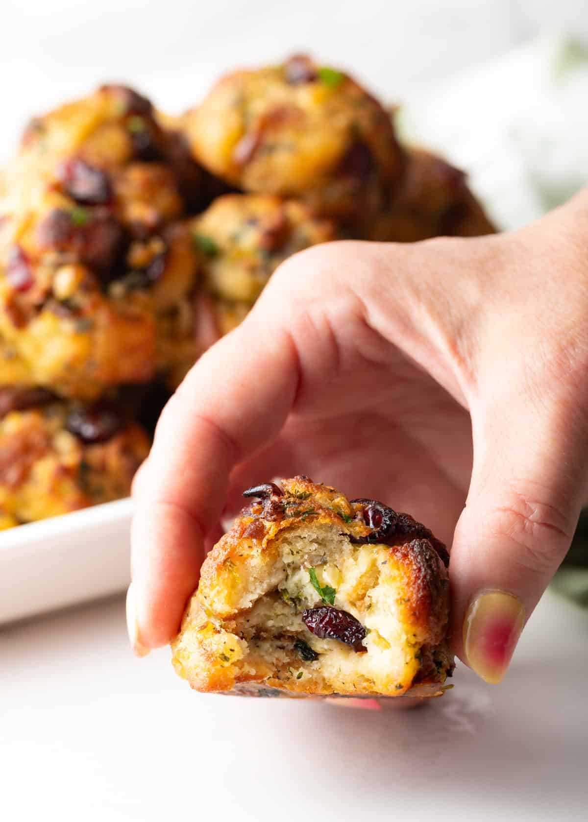 Hand holding a bitten stuffing ball to camera.