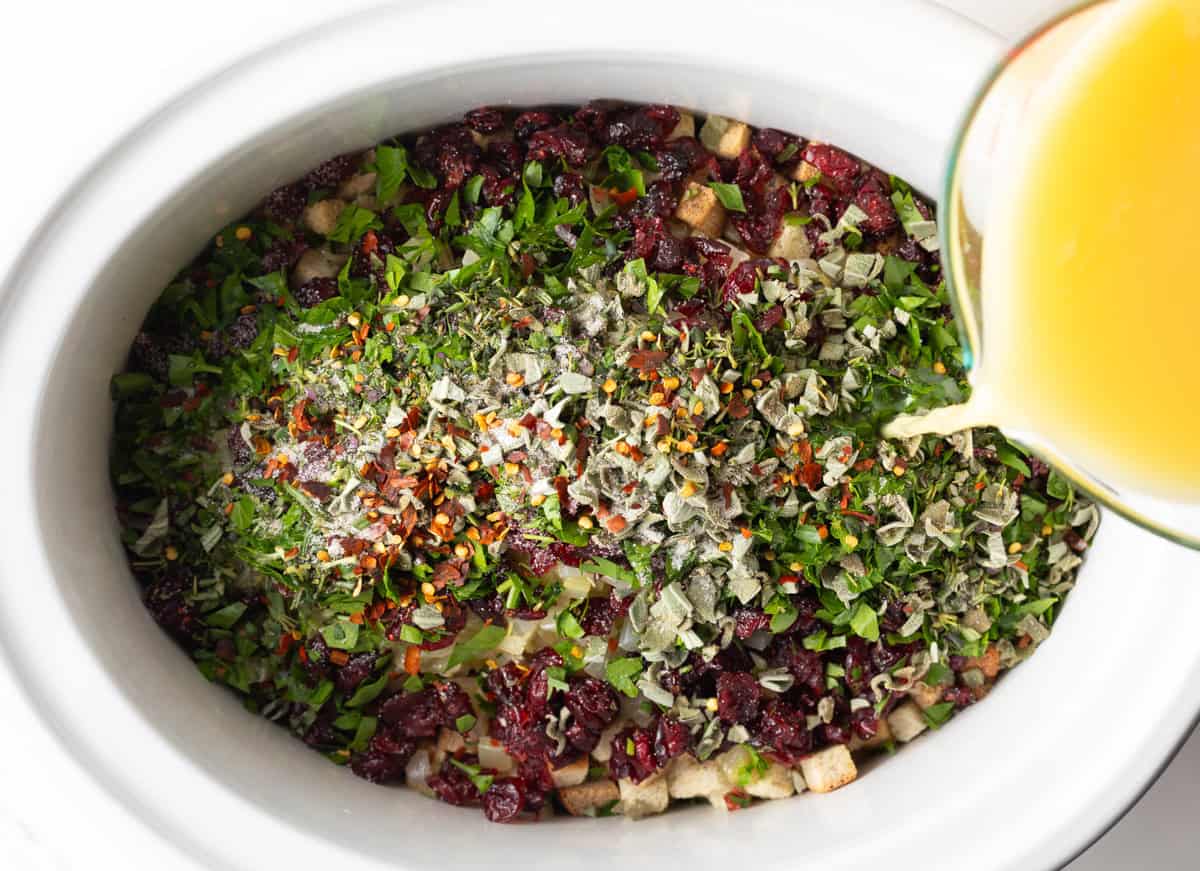 Broth being poured over ingredients for the stuffing.