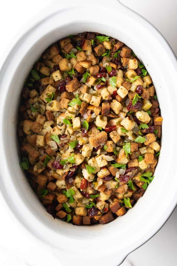 Overhead view of crock pot dressing in a white crock pot.