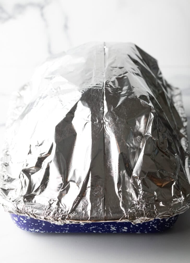Ham and pan wrapped in aluminum foil
