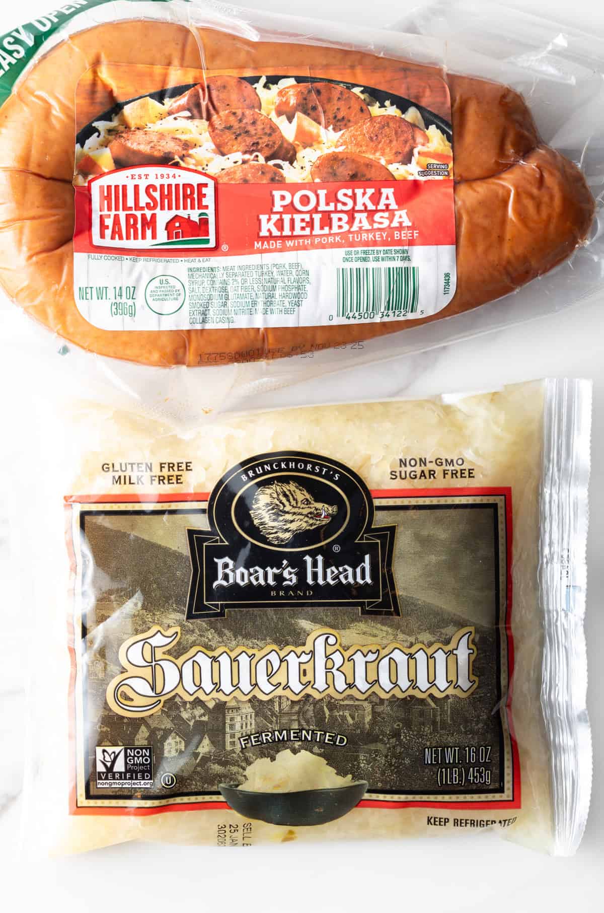 Top down view of ingredients: A package of Hillshire Farms smoked kielbasa sausage and package of Boar's Head sauerkraut