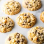 Baked potato chip cookies on white surface.