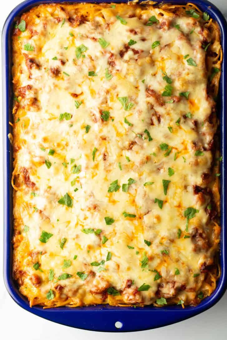 Top down view cheesy baked spaghetti casserole.