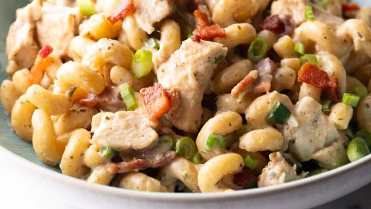 Chicken Bacon Ranch Pasta close up showing chunks of chicken breast, bacon pieces, and scallions