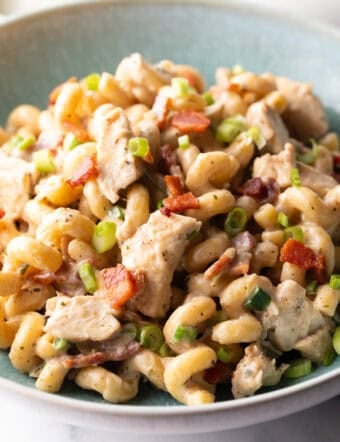 chicken bacon ranch pasta in light blue bowl, close up, showing all ingredients
